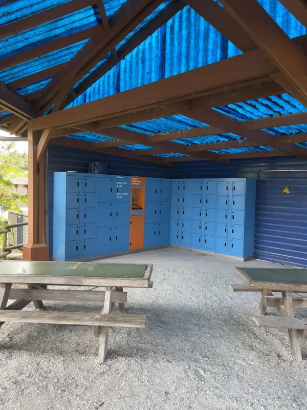 Archive photograph of blue aquarium lockers with an orange kiosk beneath a timber shelter.
